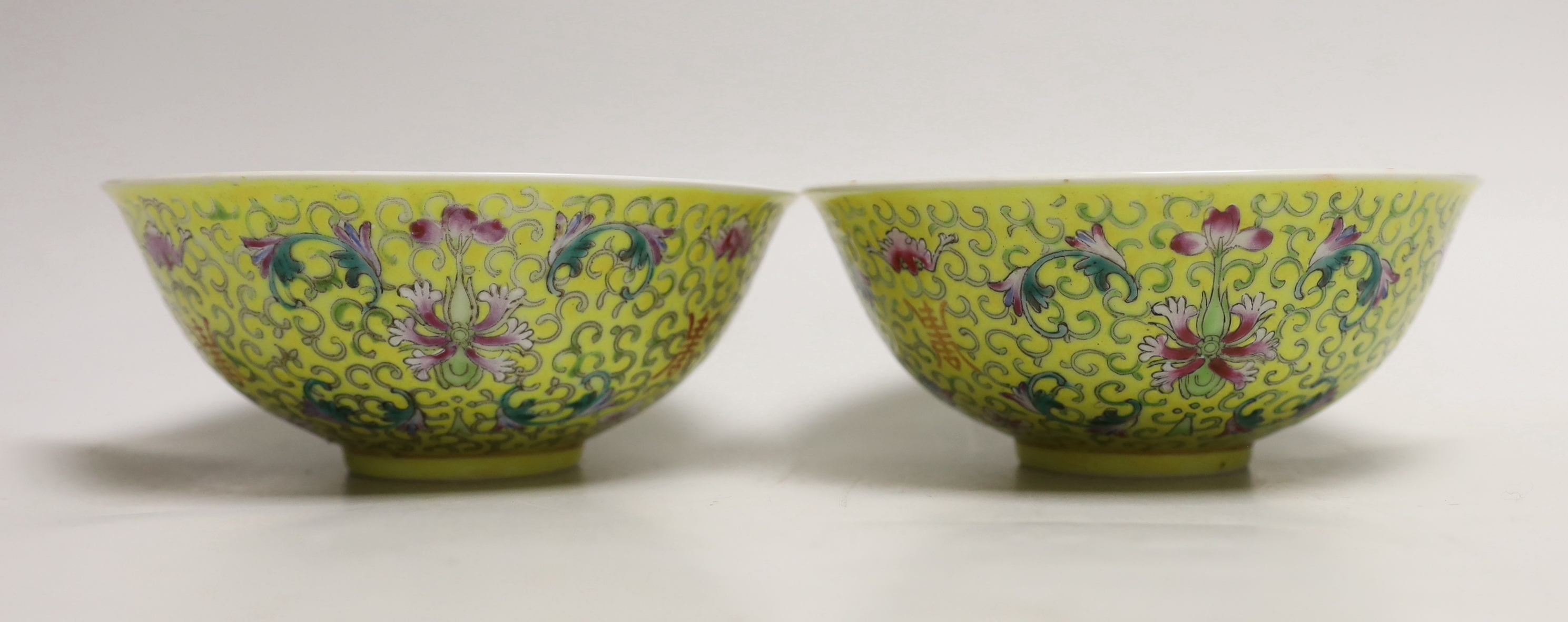 Five Chinese pink monochrome bowls decorated with dragons chasing the flaming pearl together with a yellow ground pair, largest 16cm in diameter